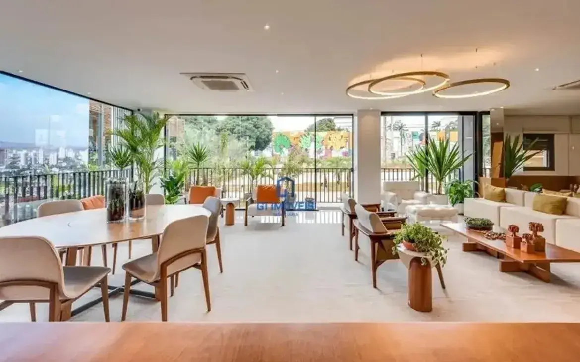 Amplo living integrado com decoração moderna, iluminação circular e vista livre no apartamento Opus Tellure.