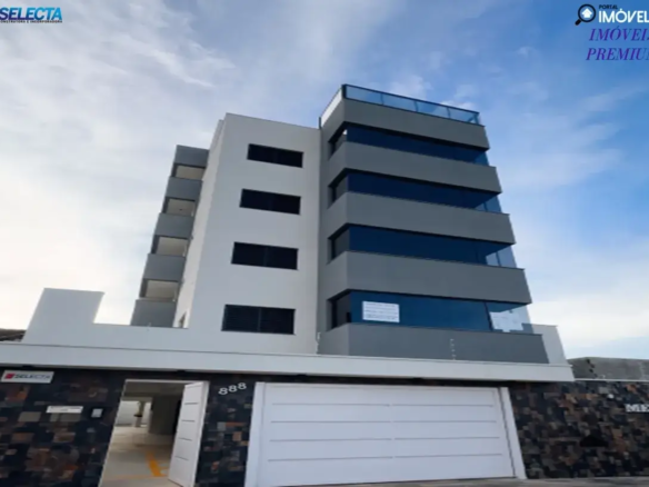 Fachada de prédio moderno no bairro Santa Mônica, Uberlândia (MG), com design minimalista em branco e cinza, varandas de vidro e muro de pedra na entrada.