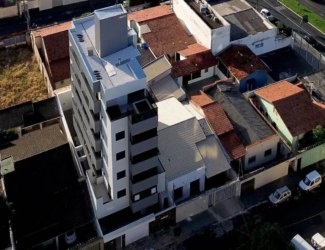 Foto aérea do Edifício Meraki, prédio moderno que contrasta com as casas do bairro Santa Mônica, em Uberlândia.