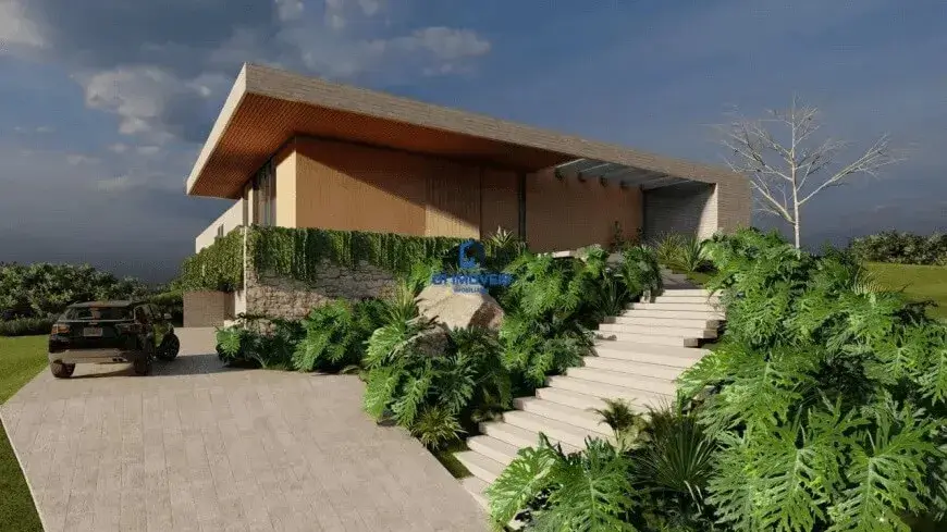 Esta imagem retrata a fachada de um imóvel de arquitetura moderna e imponente, possivelmente uma representação digital (render). Detalhes do Imóvel: Arquitetura e Estrutura: O imóvel possui um design contemporâneo, caracterizado por linhas retas e volumes bem definidos. O telhado é plano e extenso, com uma laje de cor clara (provavelmente concreto ou revestimento similar) que se projeta significativamente sobre a estrutura, criando beirais amplos. A face inferior desses beirais é revestida com um material que lembra madeira de tom quente, alaranjado/caramelo, adicionando um toque de aconchego. As paredes do nível superior parecem ser de alvenaria com acabamento liso em tom bege claro ou off-white. A base do imóvel, ou um muro de contenção/elemento paisagístico proeminente, é construído com pedras naturais de formatos irregulares, em tons de cinza, bege e marrom, conferindo um aspecto rústico e elegante que contrasta com a modernidade do restante da estrutura. Há grandes vãos e aberturas, sugerindo amplas janelas ou portas de vidro, embora o interior não seja visível. Cores Predominantes: Neutras: Bege claro/off-white (paredes superiores, laje do telhado, escadaria, piso da entrada). Naturais: Tons de cinza, bege e marrom (pedras do muro), verde intenso (vegetação), marrom/alaranjado (revestimento inferior do beiral). Escuras: Preto ou cinza escuro (SUV). Ambiente e Paisagismo: O ambiente transmite sofisticação e uma forte integração com a natureza. O paisagismo é exuberante, com destaque para plantas tropicais de folhas largas e volumosas (como filodendros ou guaimbês) em tons de verde vibrante, que margeiam a escadaria e se espalham pelo terreno. Há uma escadaria larga, feita de degraus claros (possivelmente concreto ou pedra), que leva da área de acesso de veículos ao nível principal da casa. Trepadeiras verdes cobrem parte do muro de pedras, integrando-o ainda mais ao paisagismo. No lado esquerdo, uma rampa de acesso para veículos, pavimentada com blocos retangulares de cor clara (similar à escadaria), leva a uma área onde um SUV de cor escura (preto ou cinza chumbo) está estacionado. Ao fundo e nas laterais, observa-se vegetação mais densa e um gramado bem cuidado. Uma árvore de galhos nus se destaca à direita, contrastando com a folhagem densa ao redor. O céu é parcialmente nublado, com nuvens escuras à esquerda e áreas mais claras com um pouco de azul à direita, sugerindo um final de tarde ou um dia com tempo instável, o que confere um certo drama à cena. Móveis (Elementos Externos Fixos): Não há móveis externos visíveis como cadeiras ou mesas. Os "móveis" aqui seriam os elementos construtivos e paisagísticos que compõem a cena externa. A escadaria e a rampa de acesso são elementos funcionais e estéticos importantes. Grandes rochas naturais estão integradas ao paisagismo próximo à escada, servindo como elementos decorativos. Em resumo, a imagem apresenta um imóvel de luxo com design moderno, caracterizado pelo uso de materiais naturais como pedra e madeira em contraste com superfícies lisas e claras, inserido em um ambiente com paisagismo tropical rico e bem planejado.