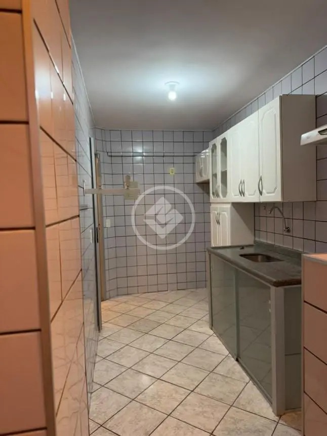 Cozinha e área de serviço integradas com azulejos até o teto e armários aéreos no Residencial Hayward.