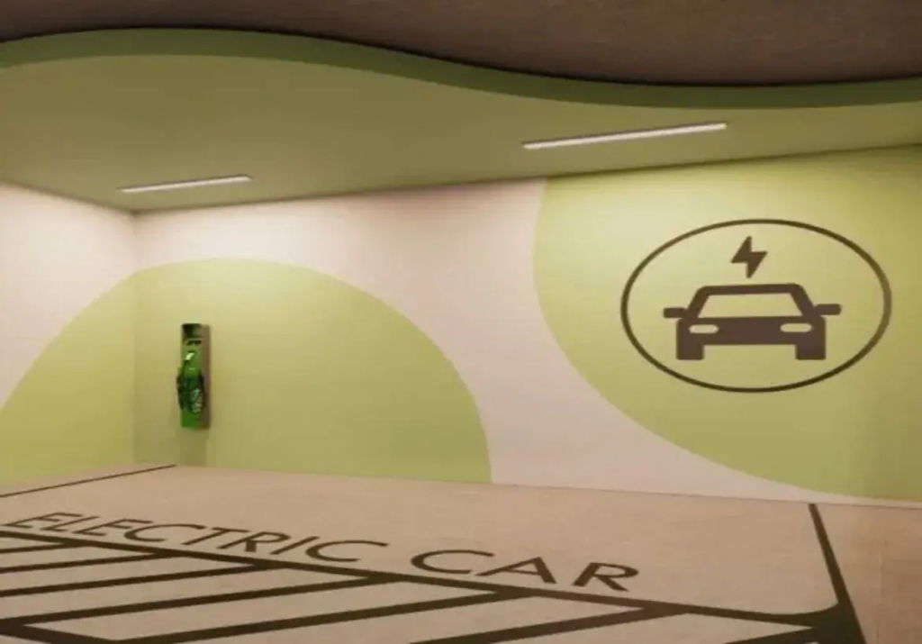 A imagem mostra uma vaga de estacionamento interna, especificamente designada para o carregamento de veículos elétricos. O espaço é bem iluminado por duas luminárias de teto longas e retangulares, de luz branca.
O piso da vaga é de cor clara, possivelmente concreto polido ou epóxi cinza claro, e possui marcações proeminentes em cinza escuro ou preto. Na parte mais próxima do observador, lê-se em letras maiúsculas "ELECTRIC CAR". Abaixo do texto, faixas diagonais preenchem a área da vaga, delimitando claramente o espaço reservado.
As paredes são predominantemente brancas, mas decoradas com grandes formas curvas pintadas em um tom de verde claro, quase pistache. Na parede do fundo, à esquerda, está instalada a Estação de Recarga para Veículos Elétricos. É um equipamento vertical, de cor verde vibrante, montado na parede, com o que parece ser um cabo de carregamento enrolado ou pendurado na sua frente.
Na parede da direita, uma grande forma circular em verde claro serve de fundo para um símbolo universal de carregamento de veículos elétricos: um ícone estilizado de um carro (visto de frente) com um símbolo de raio (eletricidade) acima dele, tudo dentro de um círculo, em cor cinza escuro ou preto.
O teto é predominantemente branco, mas acompanha a parede do fundo com uma faixa curva rebaixada ou saliente, também pintada em verde claro, que segue a linha ondulada da decoração da parede, conferindo um design moderno e coeso ao ambiente. A atmosfera geral é limpa, funcional e claramente sinalizada para sua finalidade.
Palavra chave:
Apartamento com 2 Quartos a Venda Azure Compact Life Marista