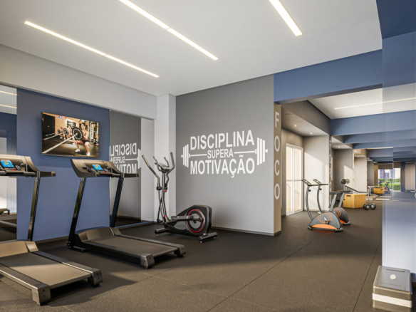 Academia completa com esteiras, aparelhos de musculação e frase motivacional na parede do Now 111.