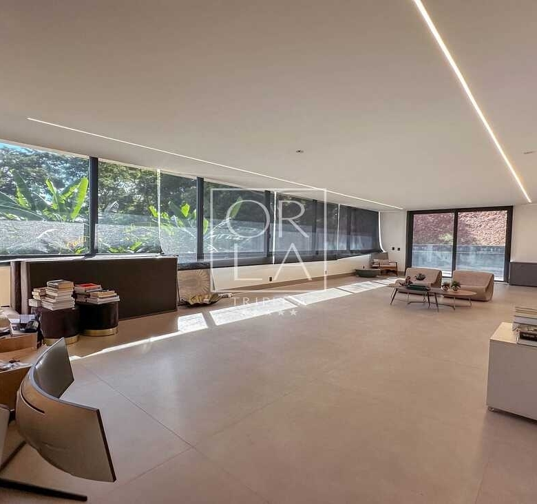 Salão espaçoso e moderno, com balcão e mesa com livros