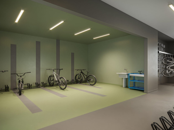 Bicicletário com suportes de parede, bancada de ferramentas e paredes em tons de verde e cinza.