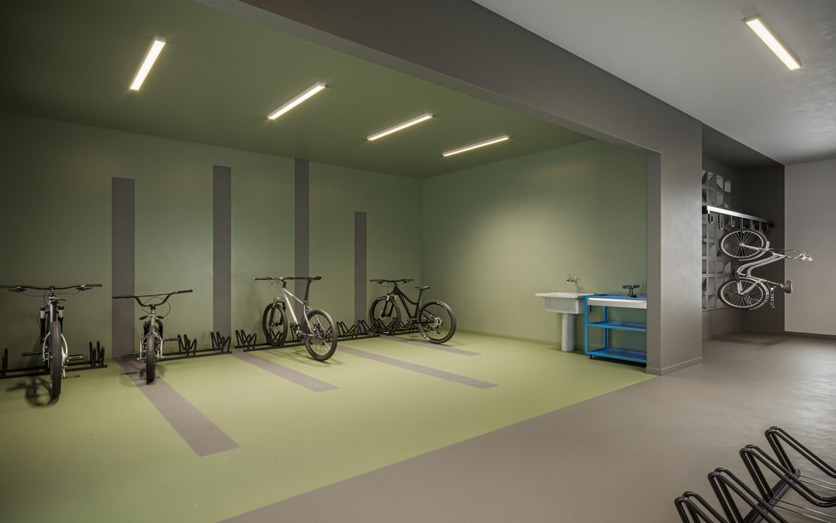 bicicletario-condominio-moderno Bicicletário com suportes de parede, bancada de ferramentas e paredes em tons de verde e cinza.