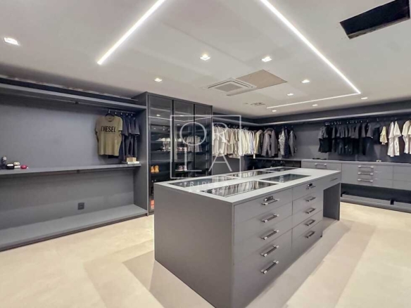 Closet walk-in com ilha central para acessórios e organização impecável.