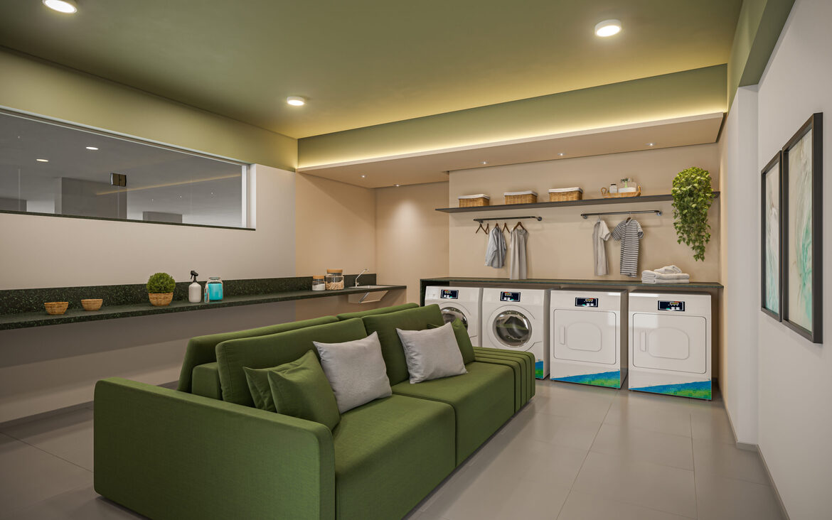 lavanderia-compartilhada-com-sofa Lavanderia compartilhada com máquinas modernas de lavar e secar e um sofá verde para espera confortável.
