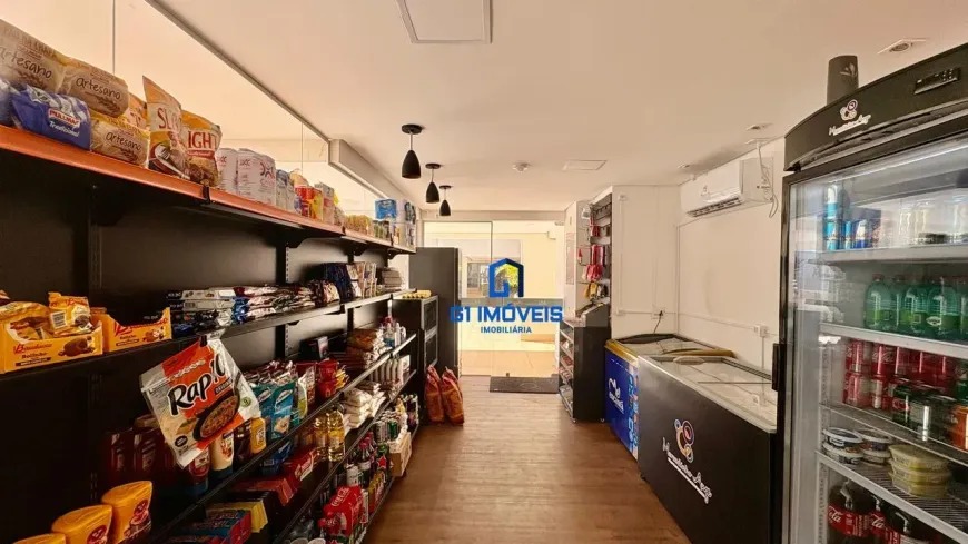 Conveniência interna do condomínio (market) com prateleiras de produtos e geladeiras de bebidas para moradores.