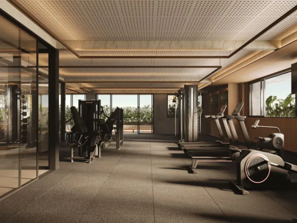 Academia moderna e equipada com esteiras e vista para jardim no condomínio Fascino Consciente.
