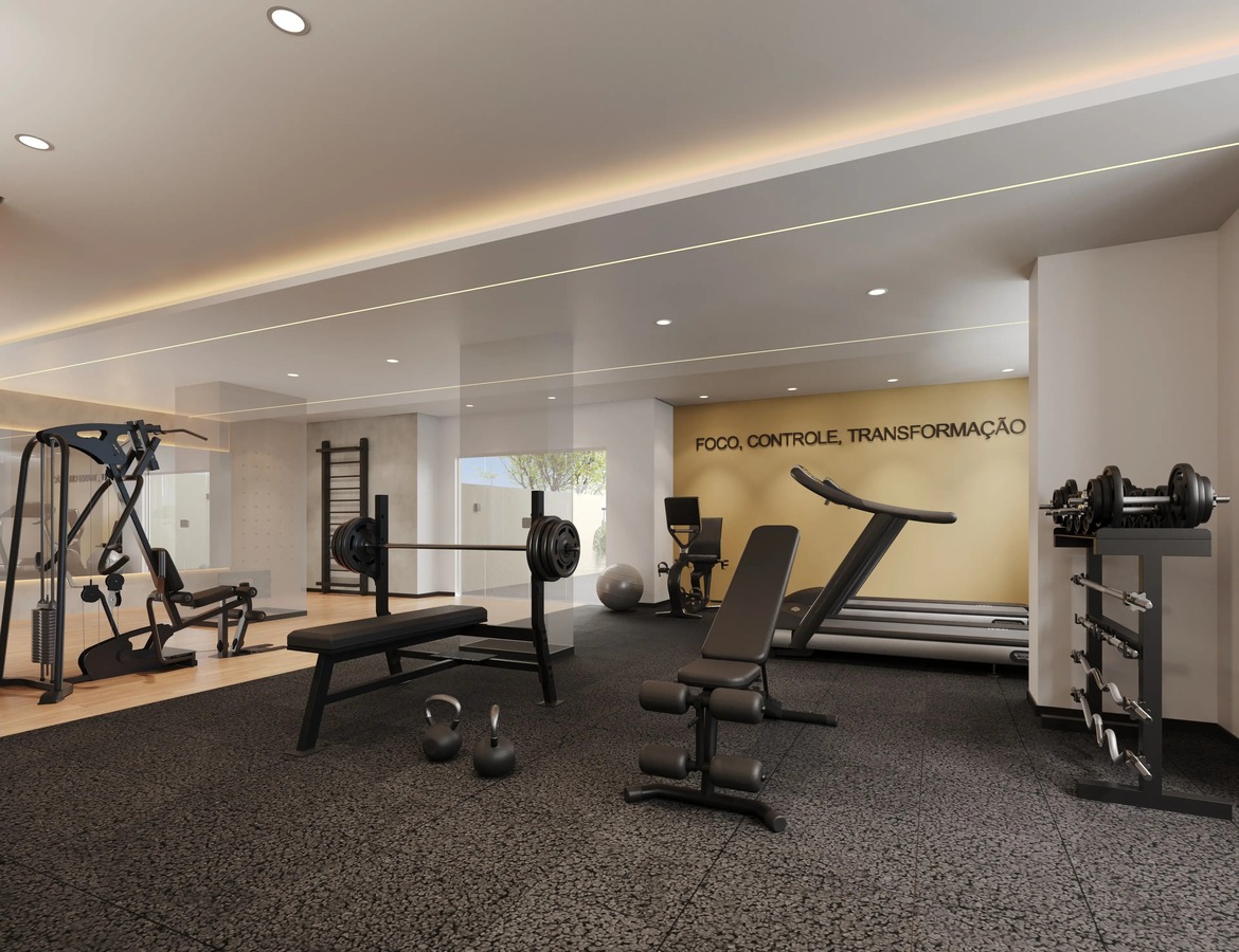 Academia do condomínio espaçosa e equipada com esteiras, pesos livres e aparelhos de musculação.