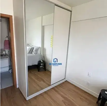 Quarto com guarda-roupa planejado branco e portas de espelho no Condomínio Residencial You.
