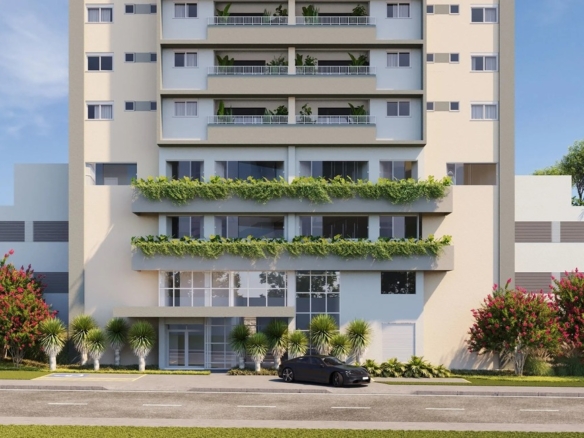 Fachada frontal moderna do edifício Varandas Flamboyant com paisagismo e varandas verdes.