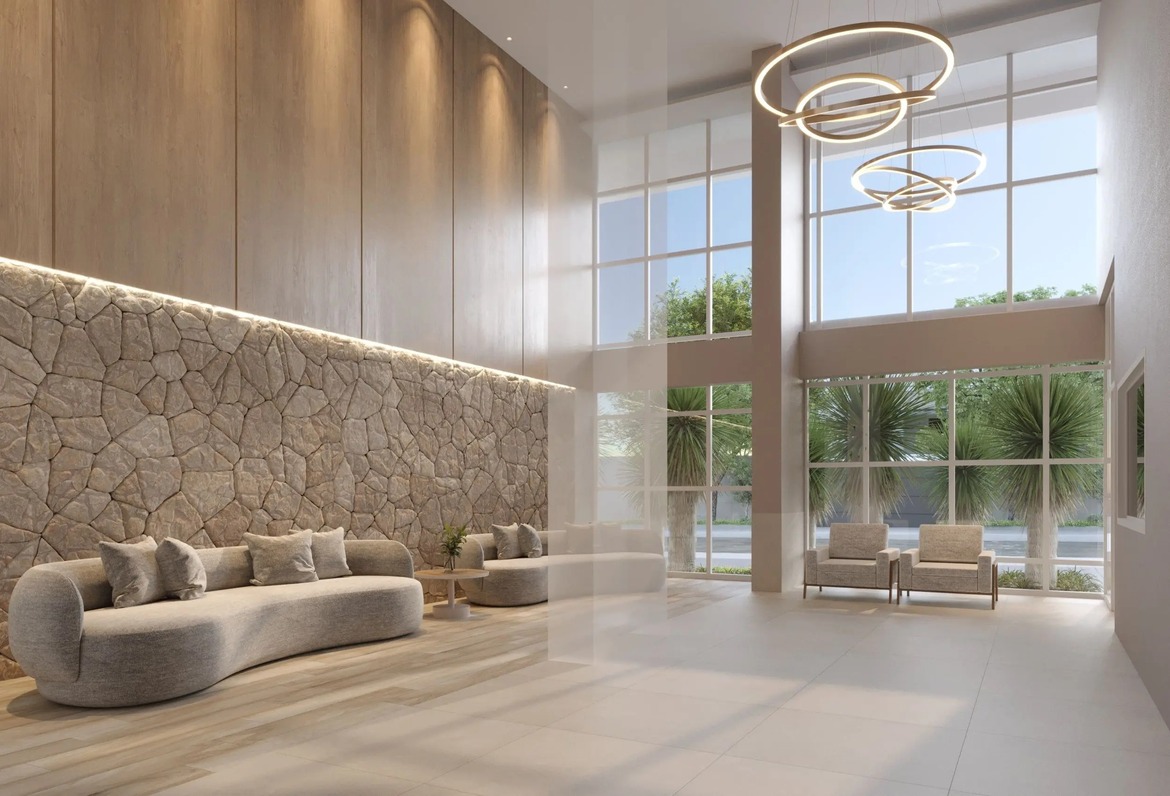 Hall de entrada imponente com pé direito duplo e parede de pedra natural no Varandas Flamboyant.