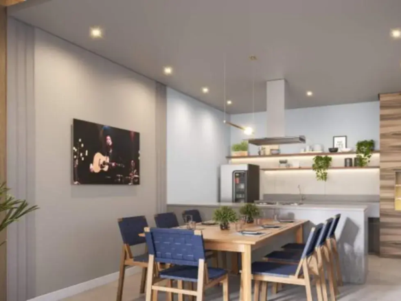 Interior de apartamento decorado mostrando sala de jantar com mesa de madeira integrada à cozinha americana moderna.