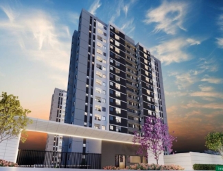 Fachada imponente das torres do empreendimento Chelsea MRV ao pôr do sol.