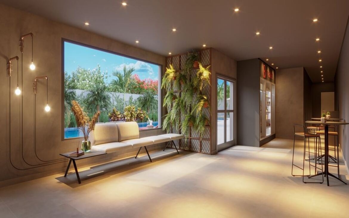 Área de convivência interna com sofá confortável, jardim vertical na parede e vista para a área externa.