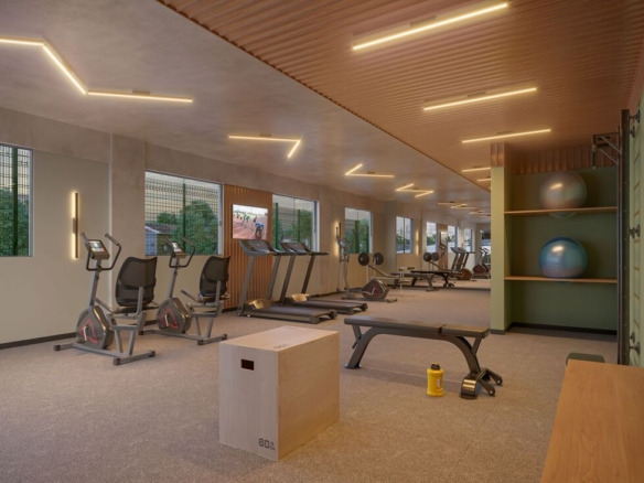 Sala de ginástica e fitness equipada com esteiras, aparelhos de musculação e bolas de pilates.