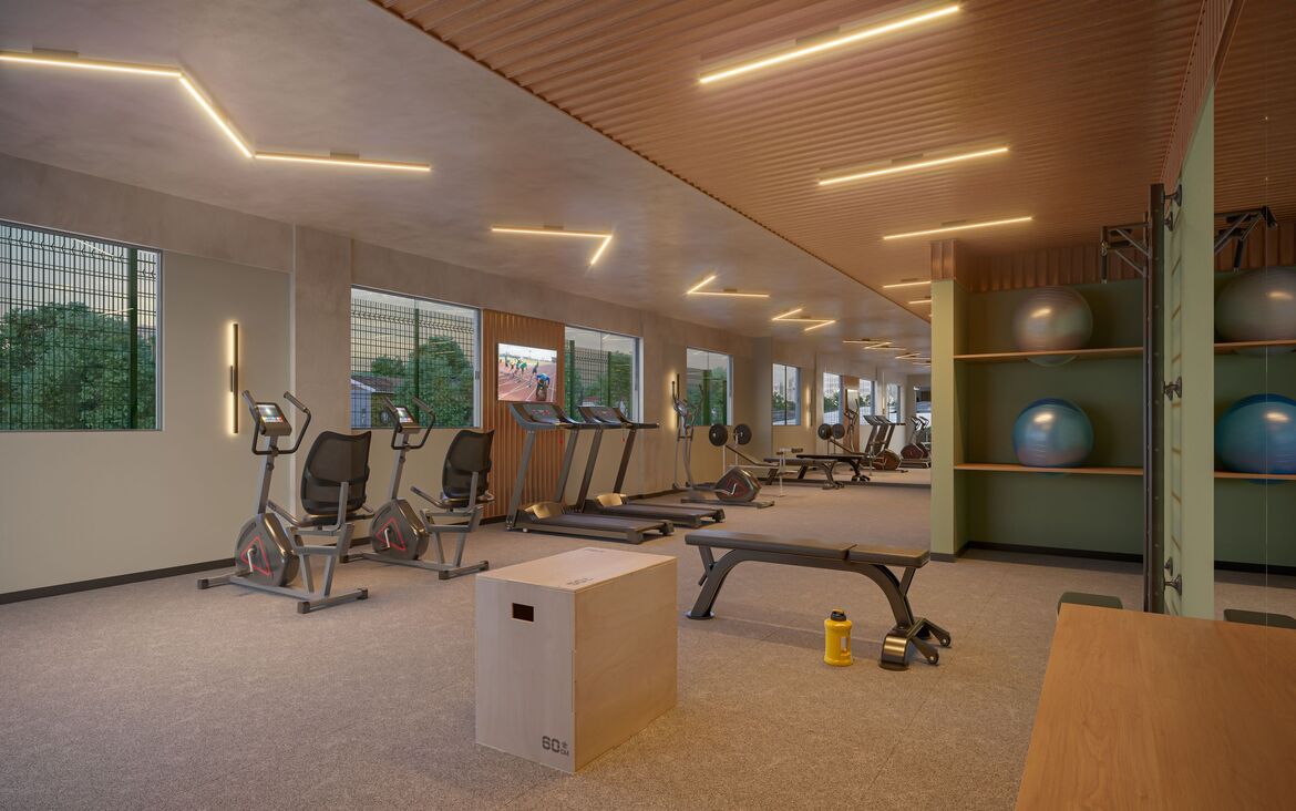 Sala de ginástica e fitness equipada com esteiras, aparelhos de musculação e bolas de pilates.
