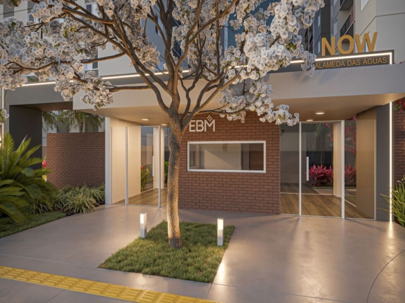 Entrada principal e guarita de acesso ao condomínio residencial com paisagismo moderno e iluminação noturna.