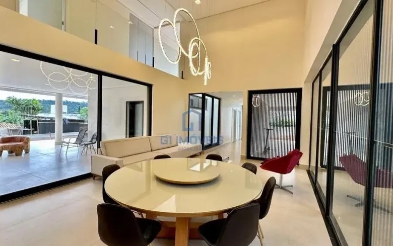 Sala de jantar ampla com mesa redonda e integração com área externa no Aldeia do Vale.
