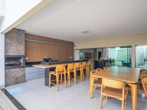 Área gourmet integrada ao quintal com bancada e banquetas