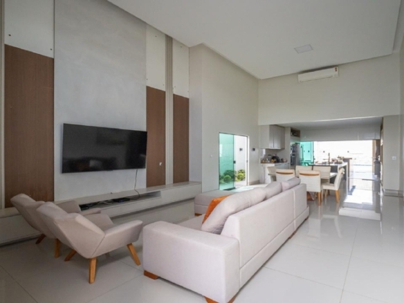 Sala de estar moderna com sofá branco e painel de televisão