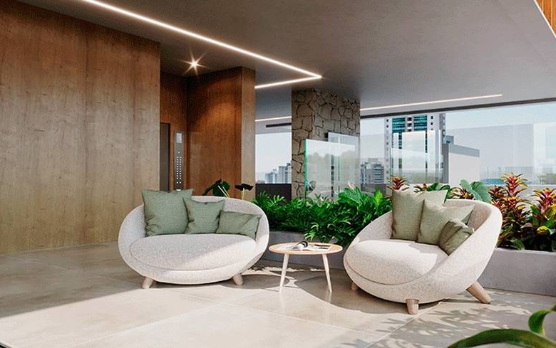 Sala de estar com sofá e mesa, além de iluminação embutida e revestimento claro