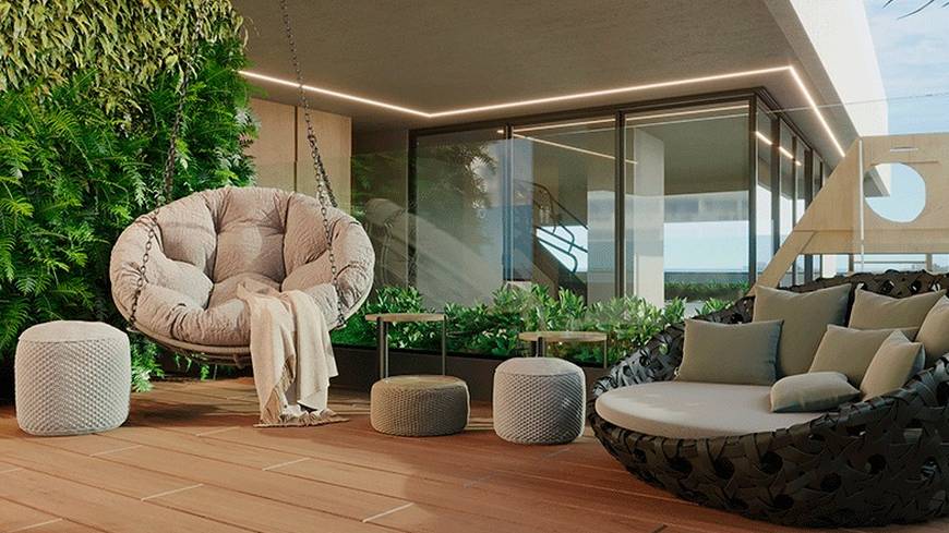 Sala de estar com sofá, mesa e poltronas, além de iluminação embutida