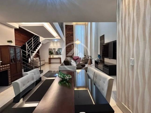 Sala de estar com mesa, cadeiras e luminária, além de iluminação embutida e revestimento de madeira no Alphaville Araguaia