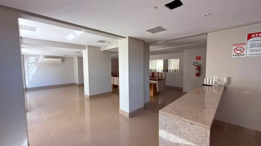 Sala de estar com teto rebaixado, além de revestimento claro